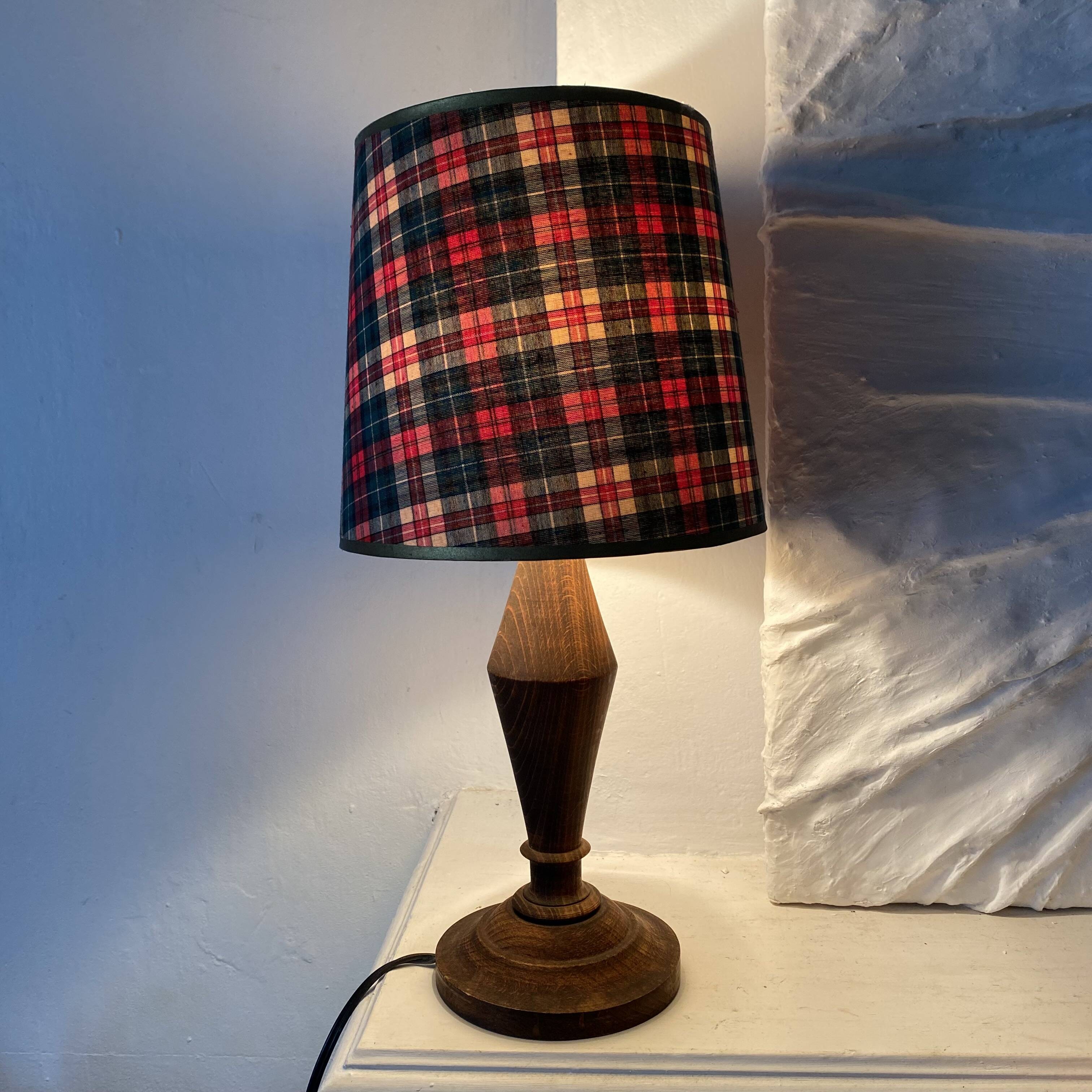 Turned wooden lamp, tartan lampshade.