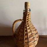 Glass bottle surrounded by wicker