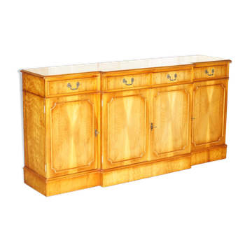 Vintage buffet made of mottled yew wood with three doors and four drawers.