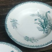 Set of three iron earthenware plates from the St Amandinoise earthenware factory, lily of the valley model.