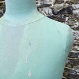 Old mannequin on wooden and fabric stand