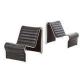 Modern black leather lounge chairs with an aluminium frame.