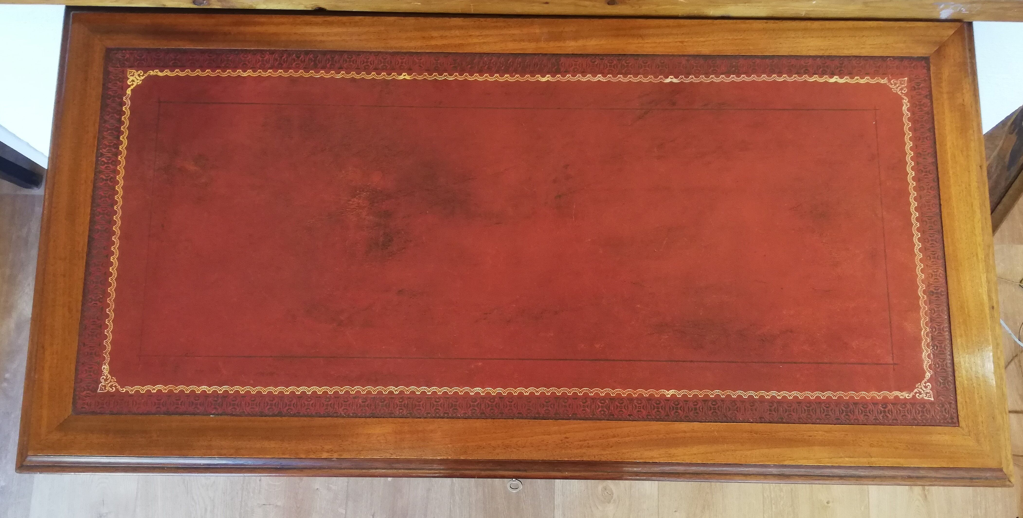 English wooden desk on top of leather
