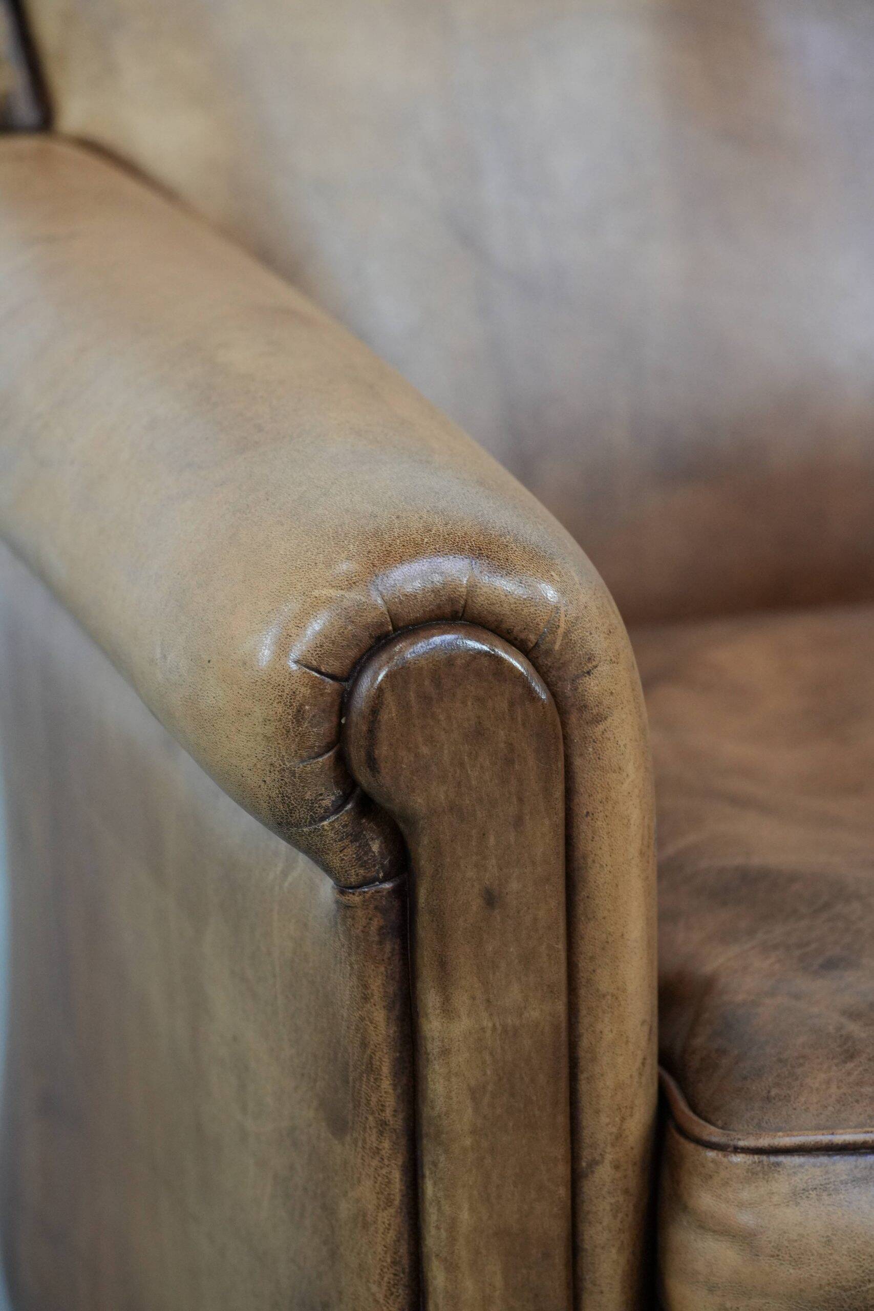 Vintage sheepskin armchair with a beautiful light colour and elegant legs