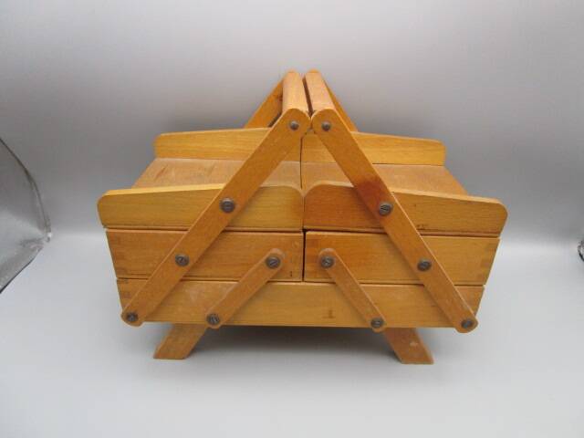 Little worker sewing old wooden table