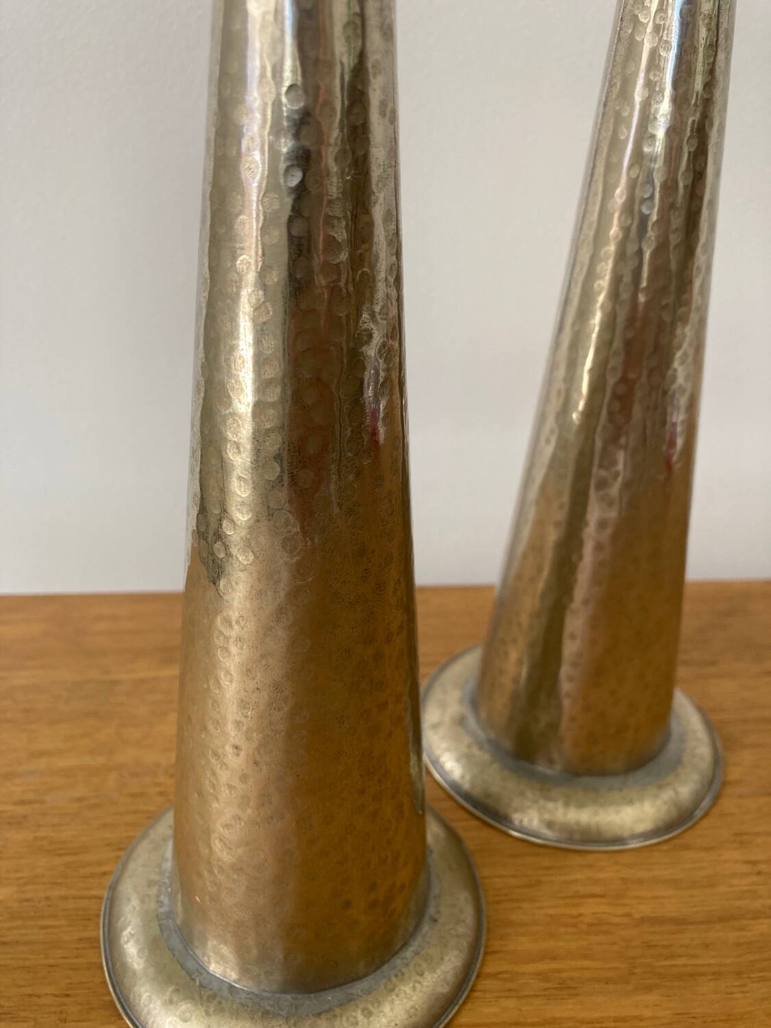 Pair of hammered metal candlesticks
