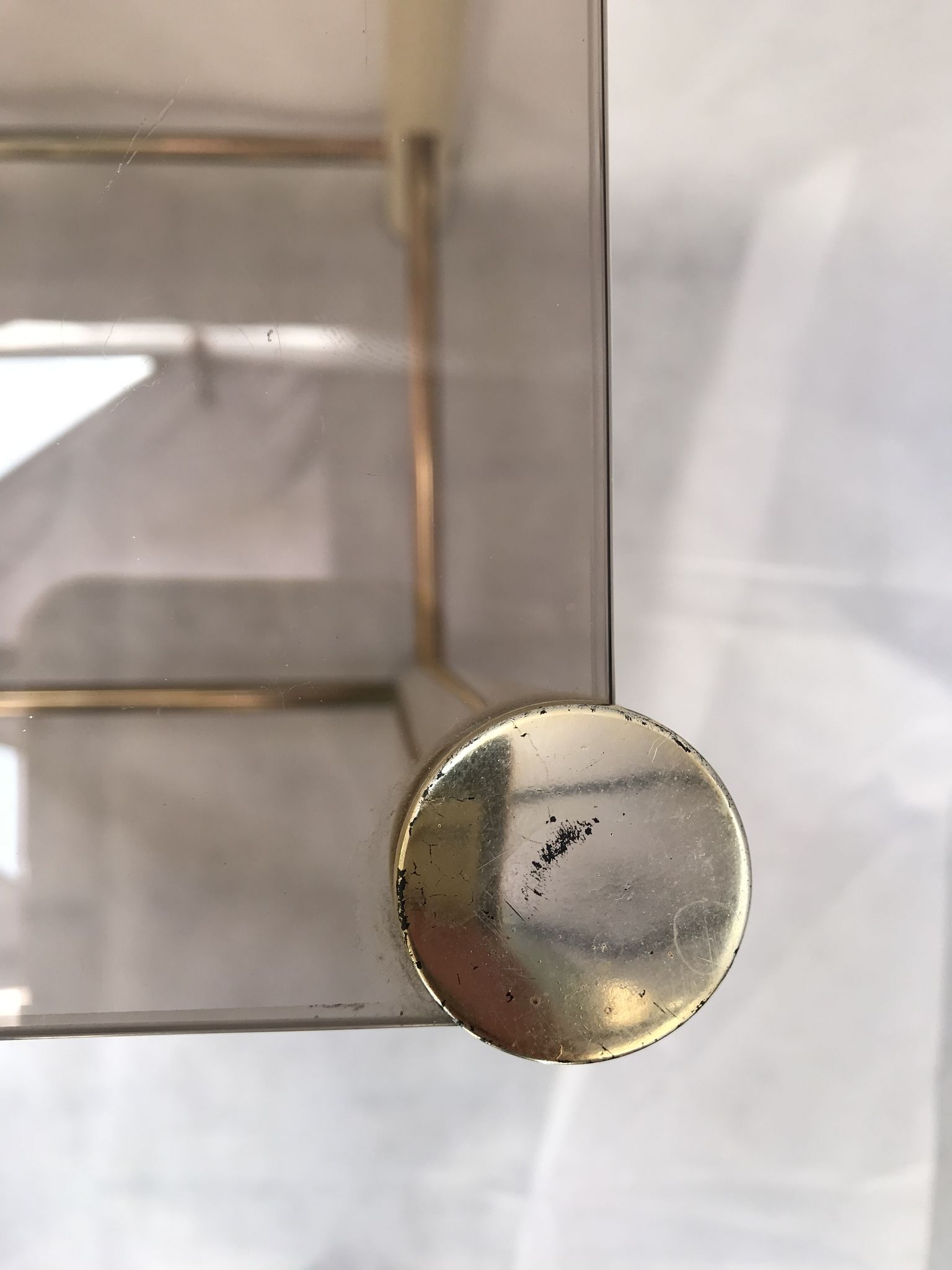 Square side table in metal and smoked glass.
