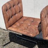 Pair of leather chairs by Robert Haussman