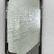 Mirror in black metal and brass with gunmetal finish