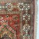 Antique wool rugs with designs on a red background, 20th century.
