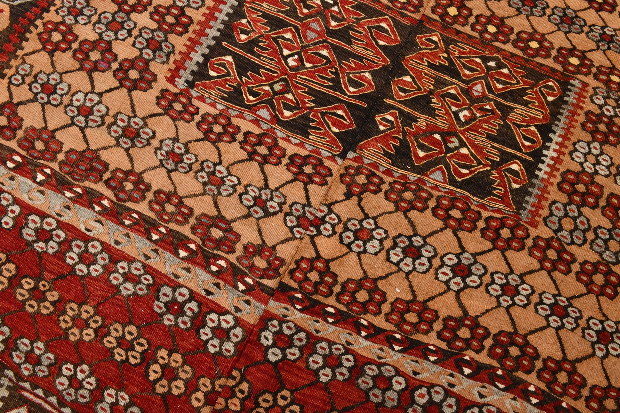 Kilim anatolien ancien tons rouges et beiges, motifs tribaux colorés
