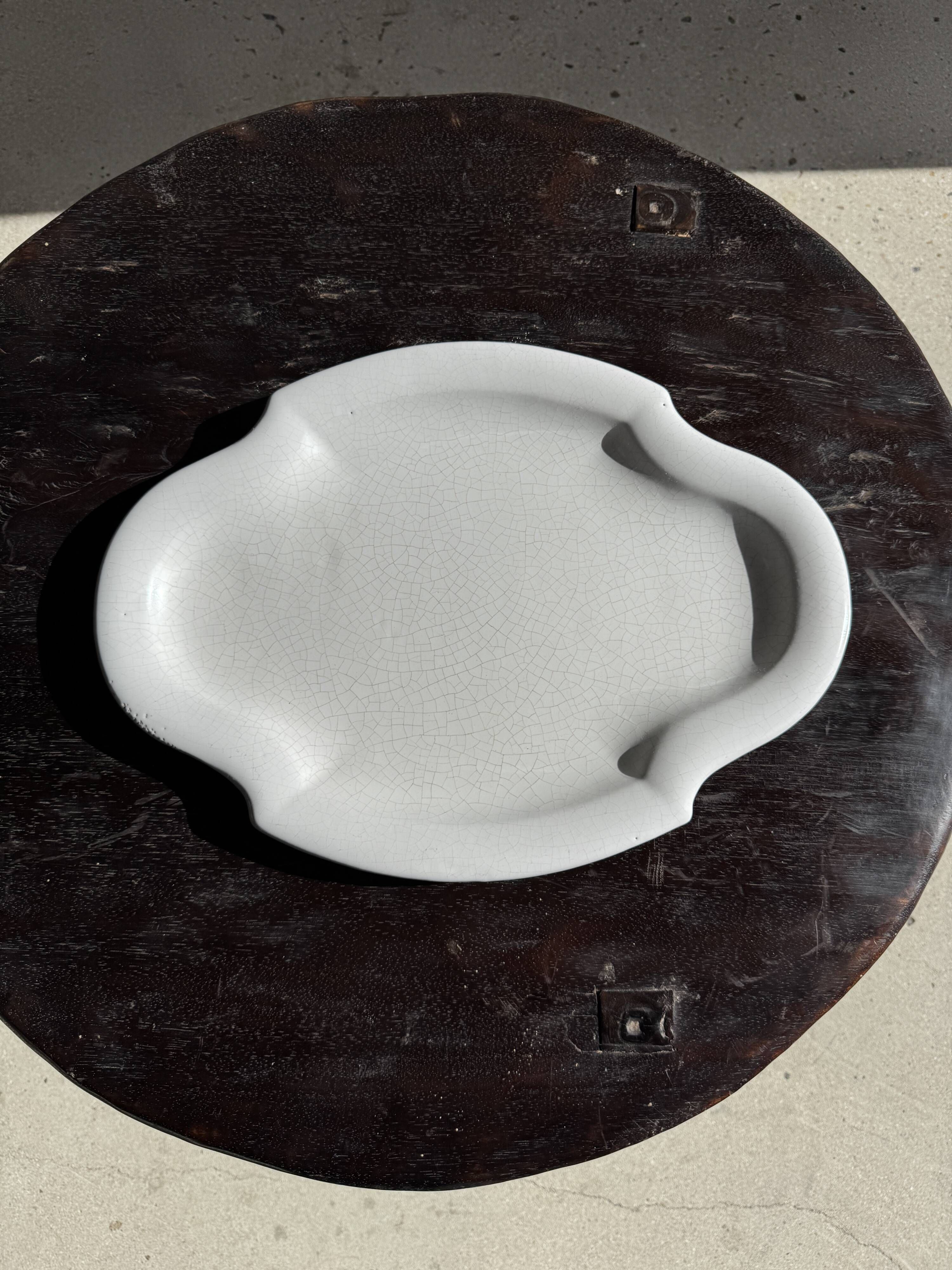 Antique oval-shaped white crackled faience plate with a scalloped edge.