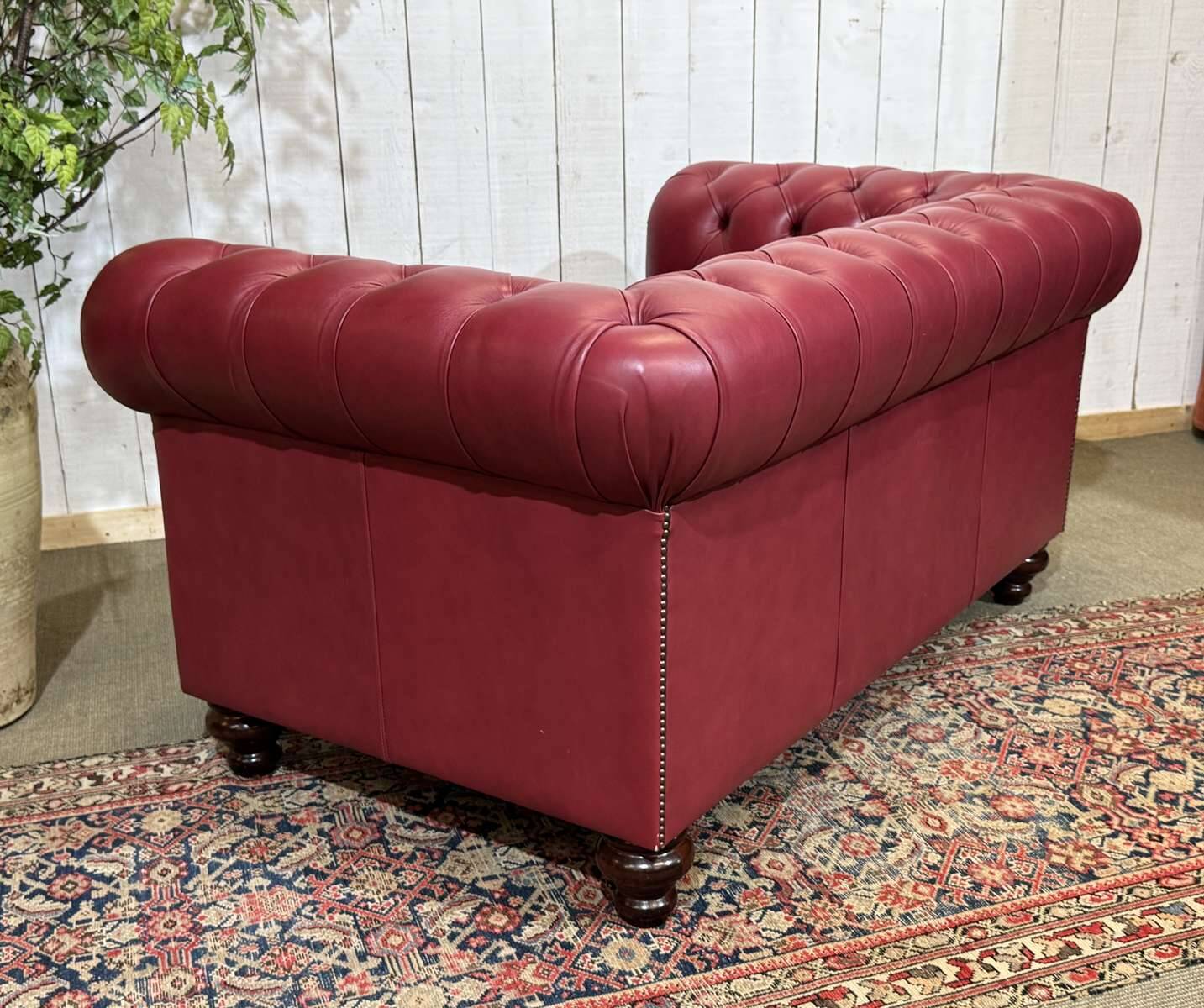 Chesterfield 2-seater leather sofa, modern production from the 2000s.