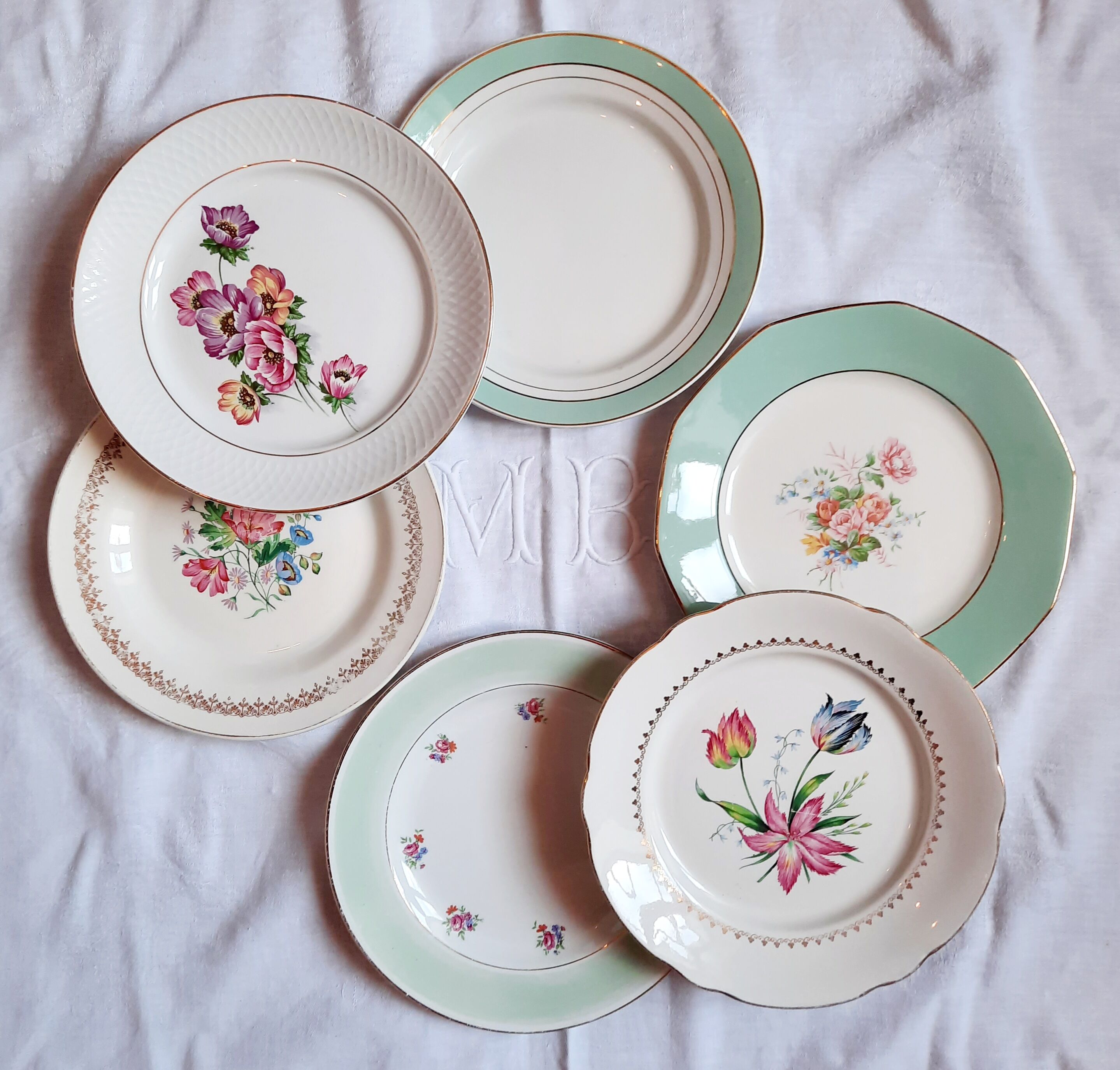 Flat antique earthenware plates with gilded edges