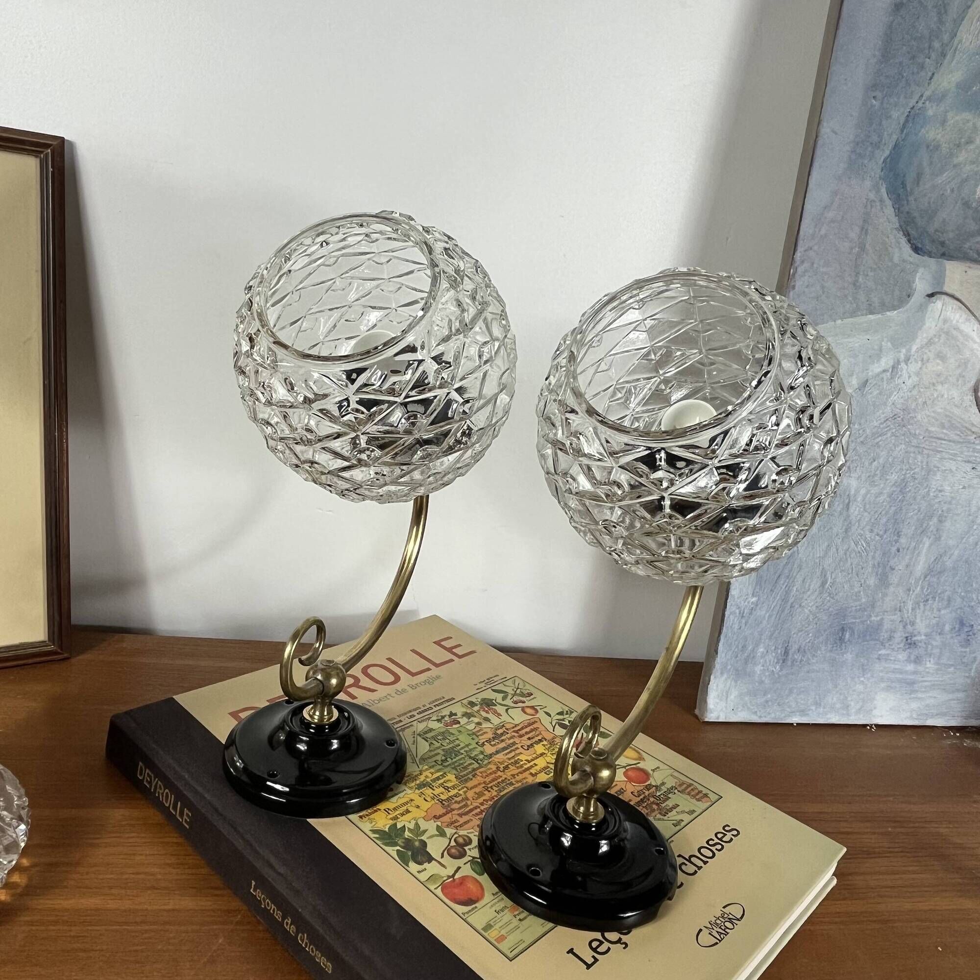 Pair of antique wall sconces with swan necks and glass globes.