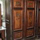Hungarian wardrobe in carved brown wood from the late 19th century, with 2 doors and a lower drawer.