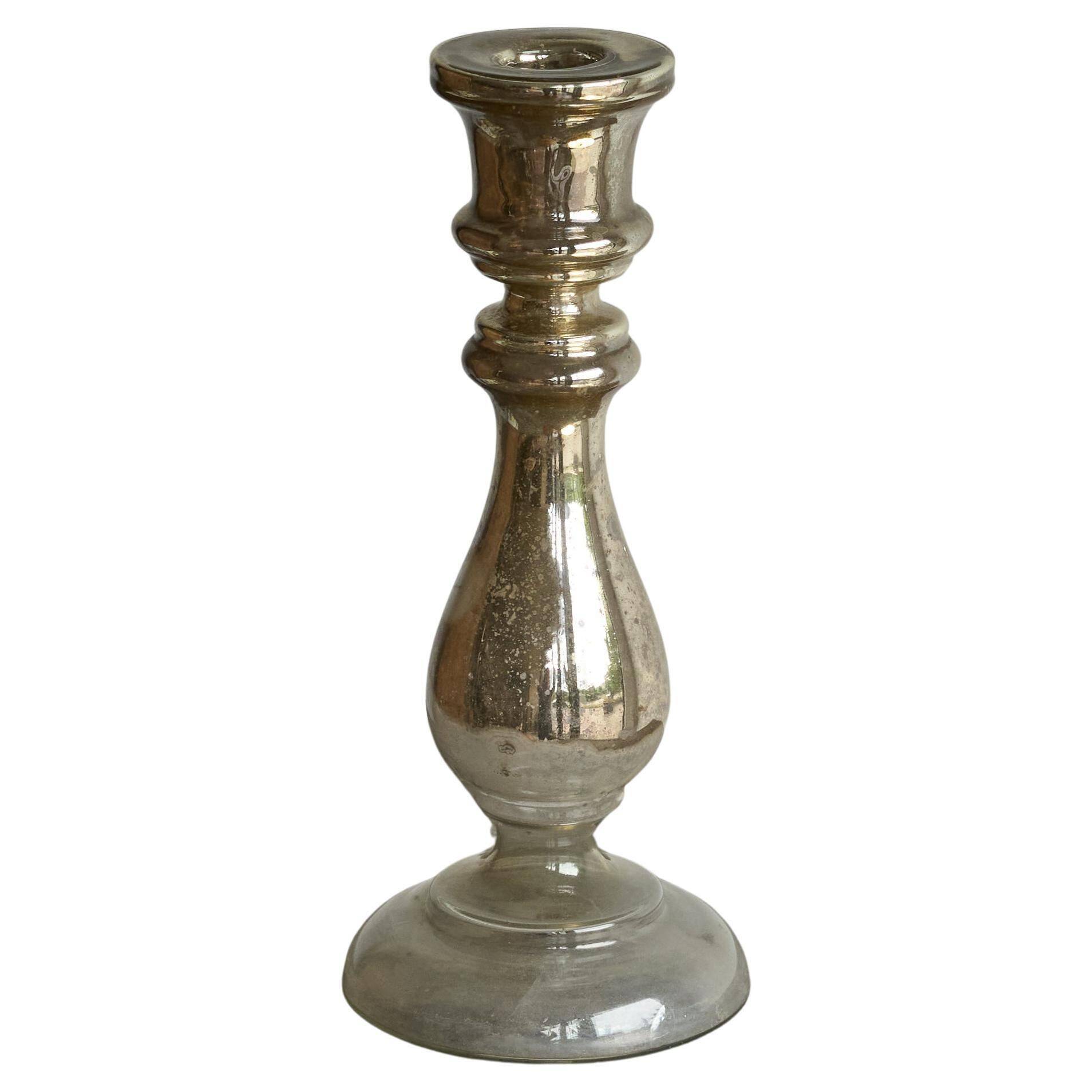 Antique mercury glass candlestick with a patina and silver finish.