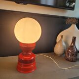 Vintage globe lamp with a metal base, perforated and lacquered in red.