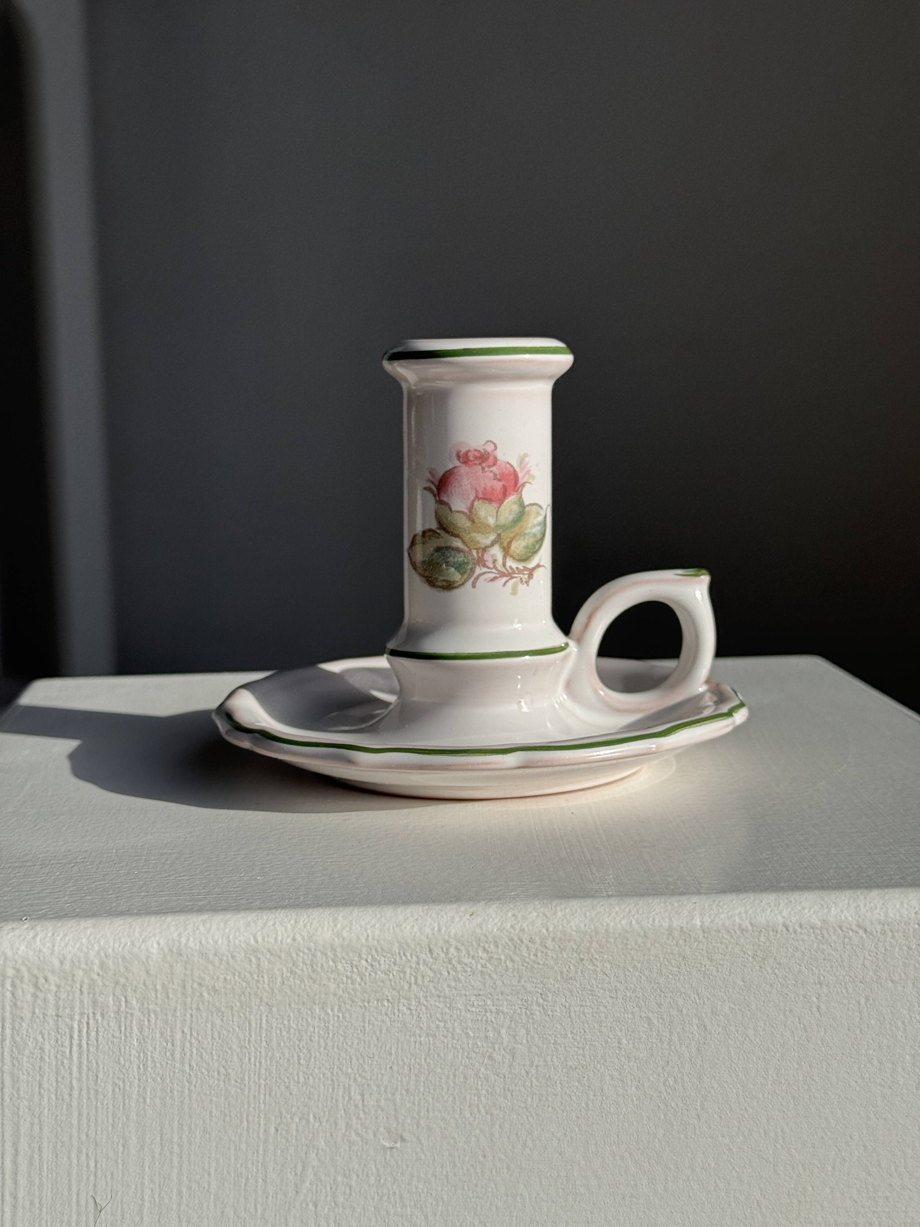 Small vintage hand-held candlestick in earthenware with green trim and floral decoration H10.5