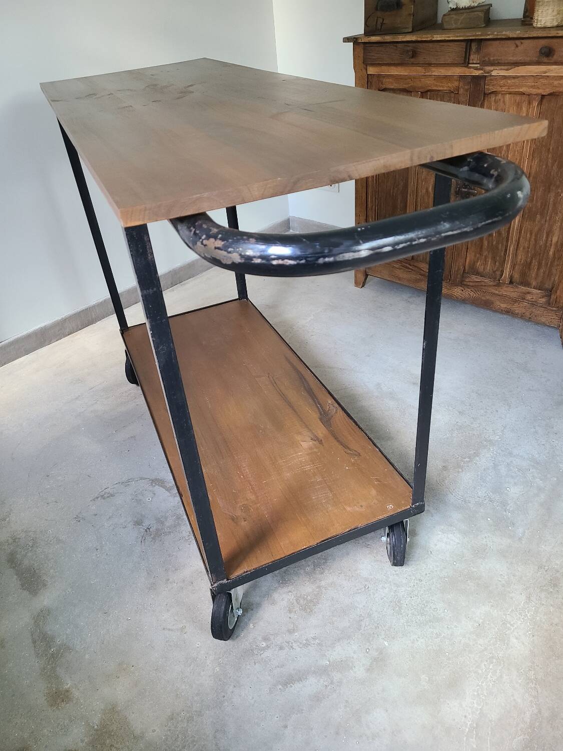 Large central kitchen island trolley on wheels serving industrial console