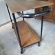 Large central kitchen island trolley on wheels serving industrial console