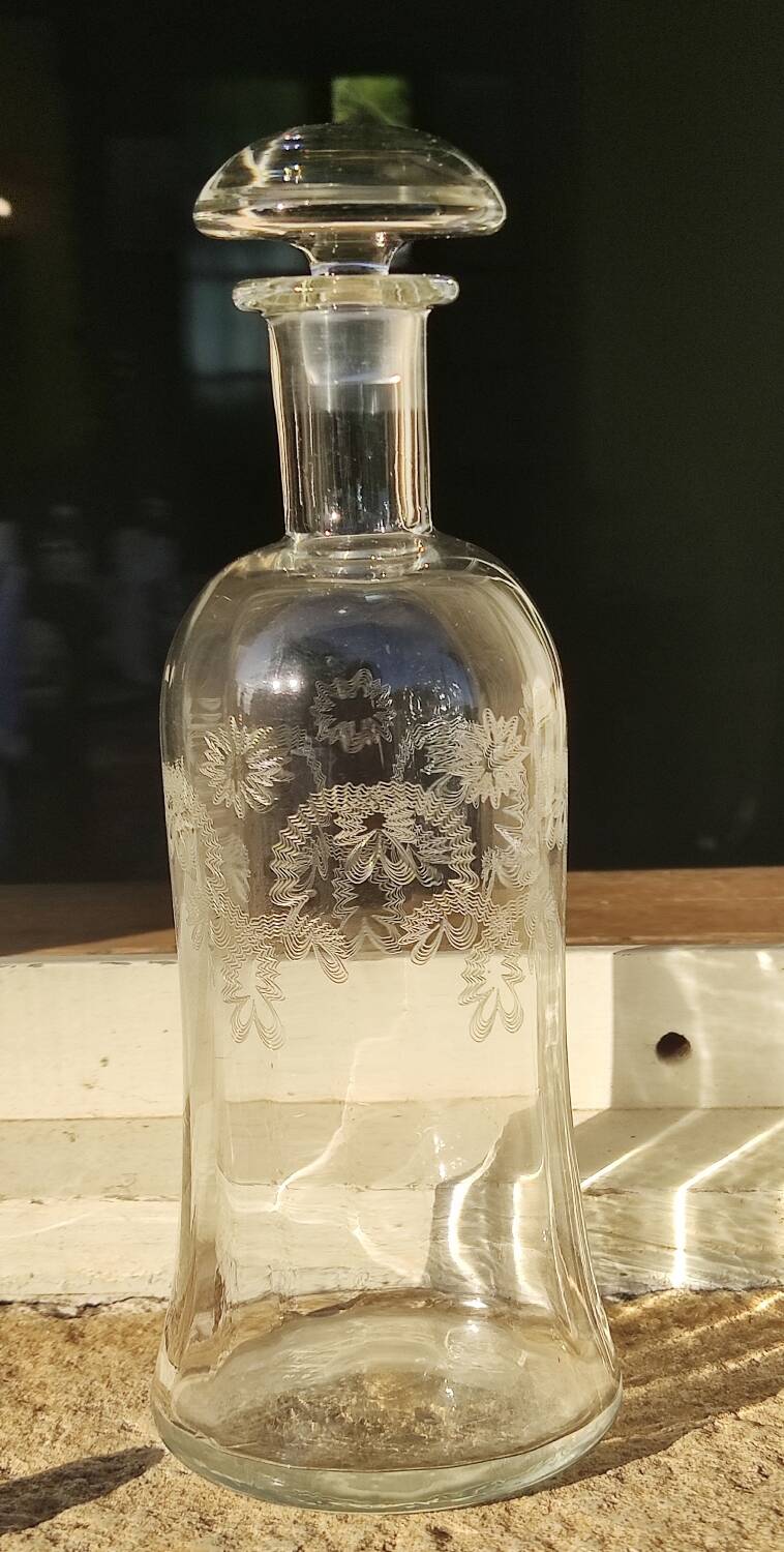Two antique engraved glass bottles