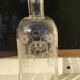 Two antique engraved glass bottles