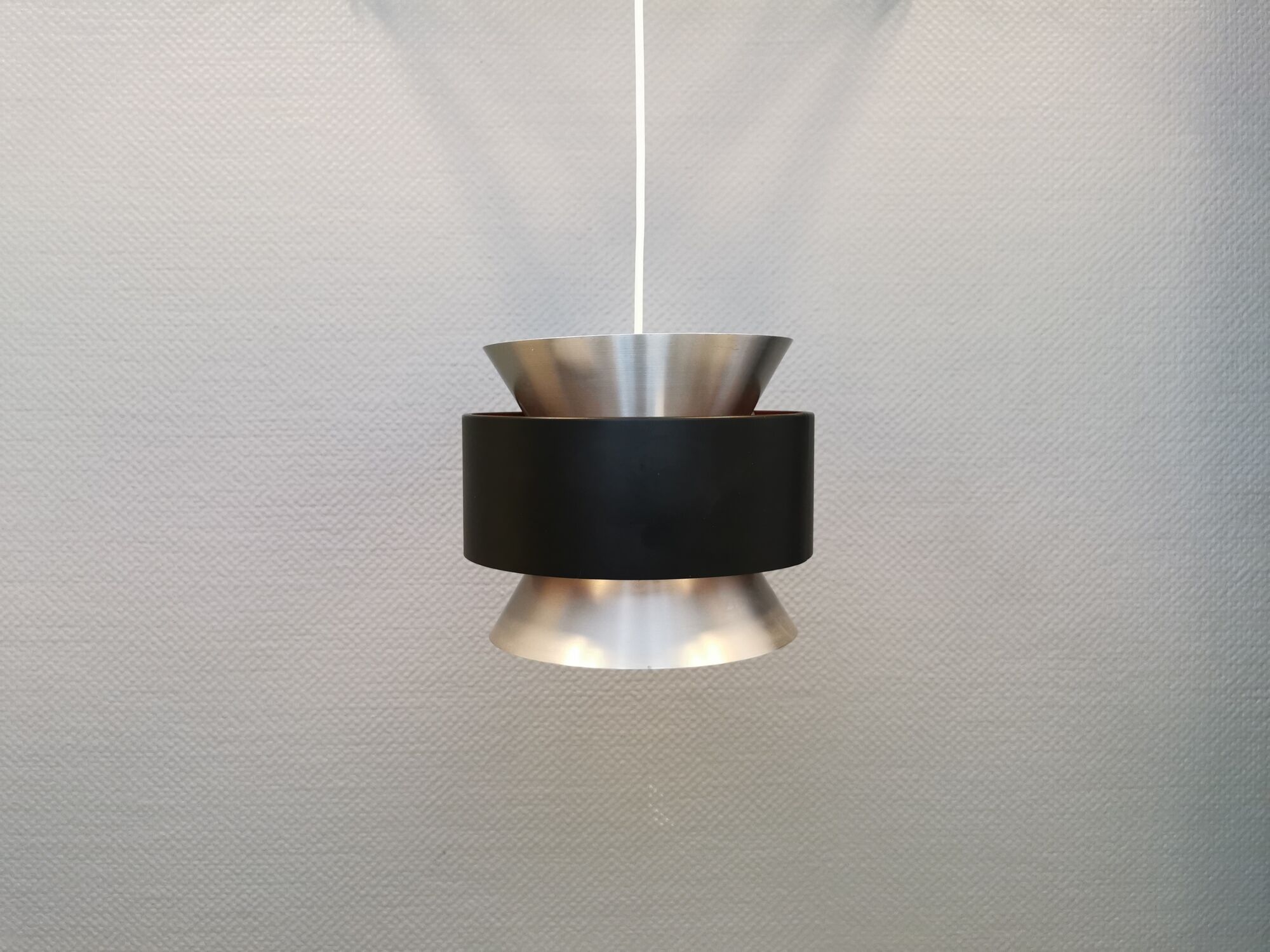 Hanging lamp,  of silver coloured aluminium with black "ring" and orange inner contrast lacquer.