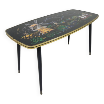 Vintage coffee table with glass top and angular, tapered legs from the 1950s