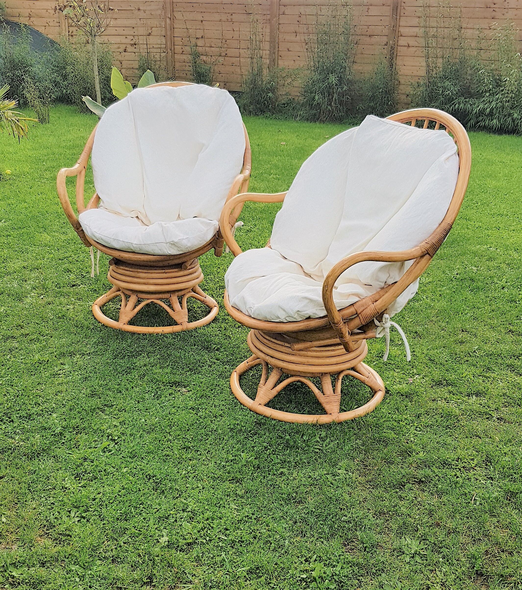 Pair of swivel rattan armchairs