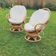 Pair of swivel rattan armchairs