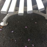 Old garden bench, cast iron feet and white wooden slats