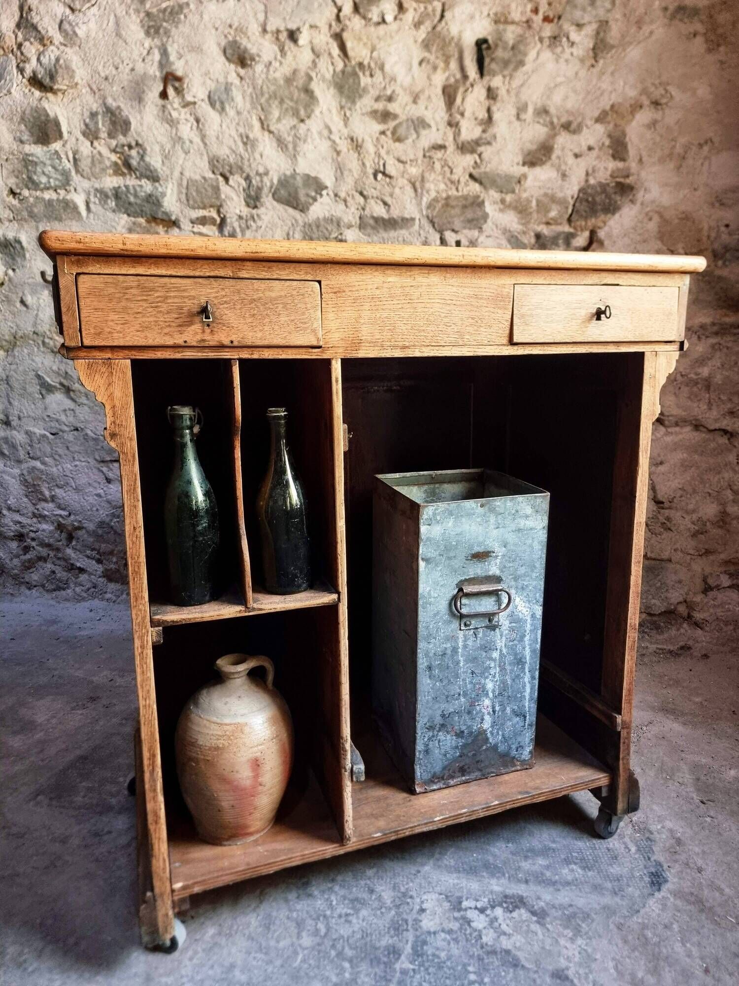 Antique French oak shop counter, kitchen island on wheels, circa 1880–1900.