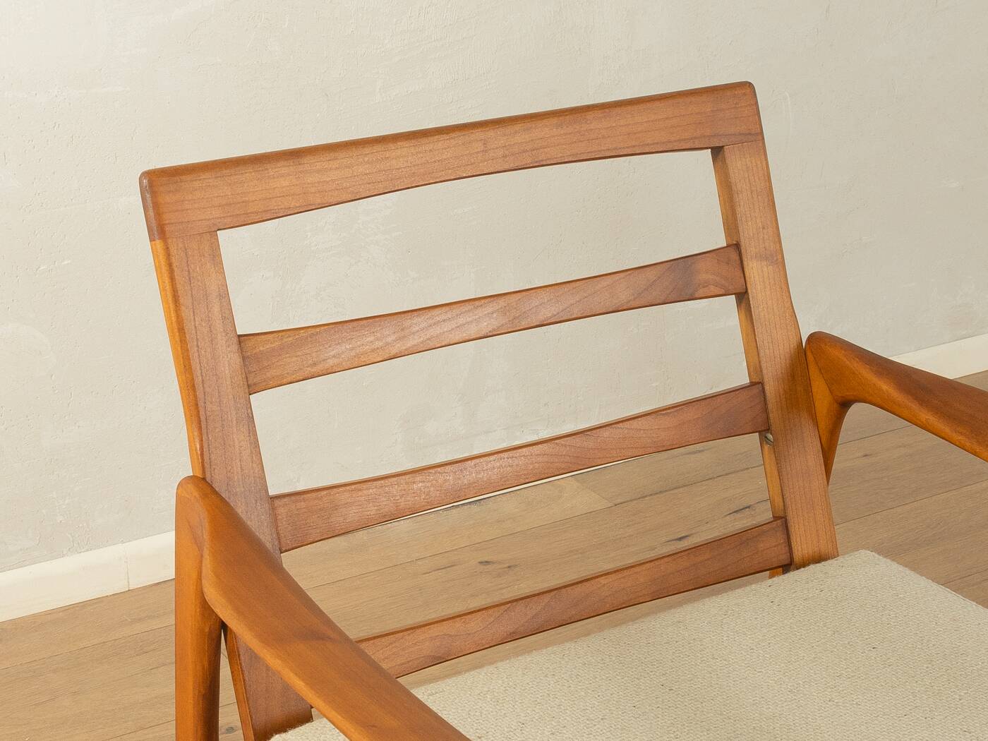 Elegant mid-century armchair from the 1960s with cream-white upholstery