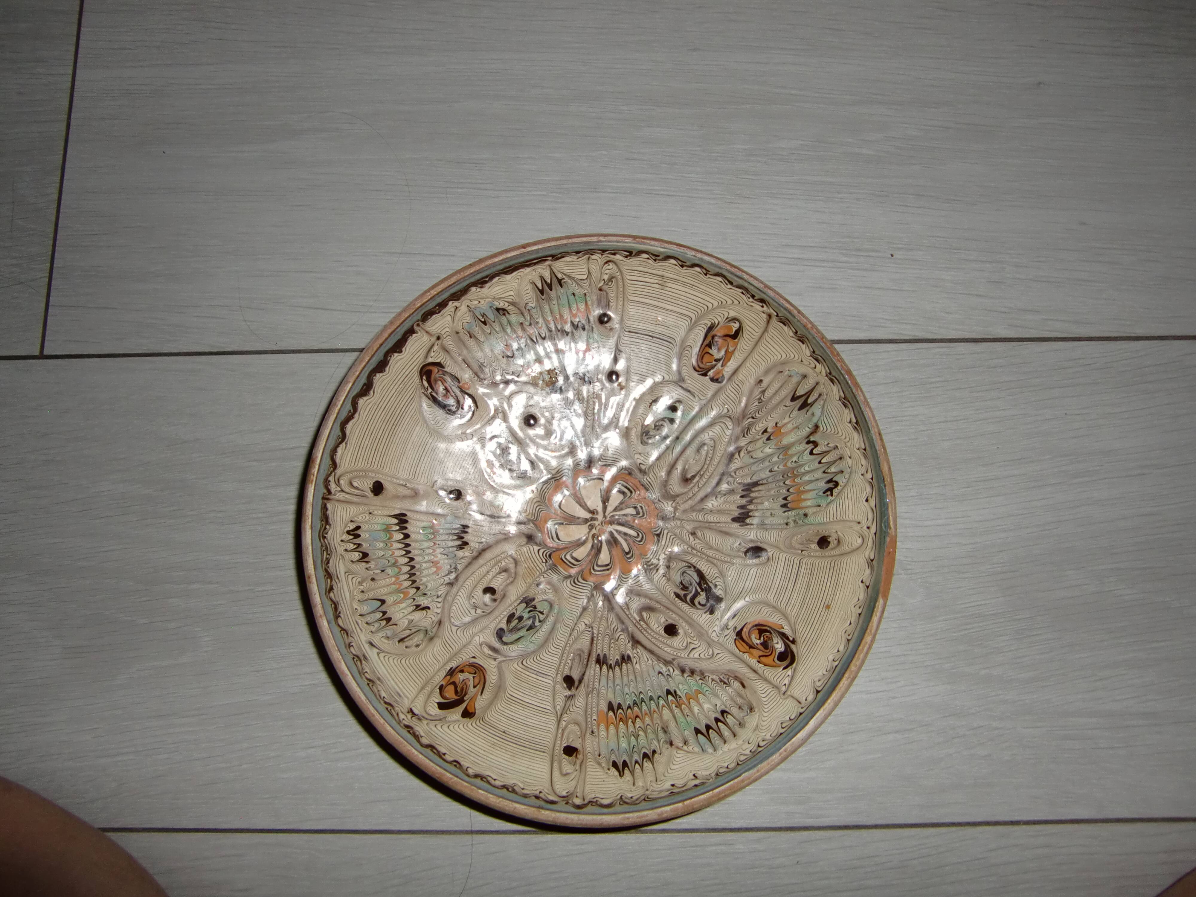Hand decorated terracotta plate
