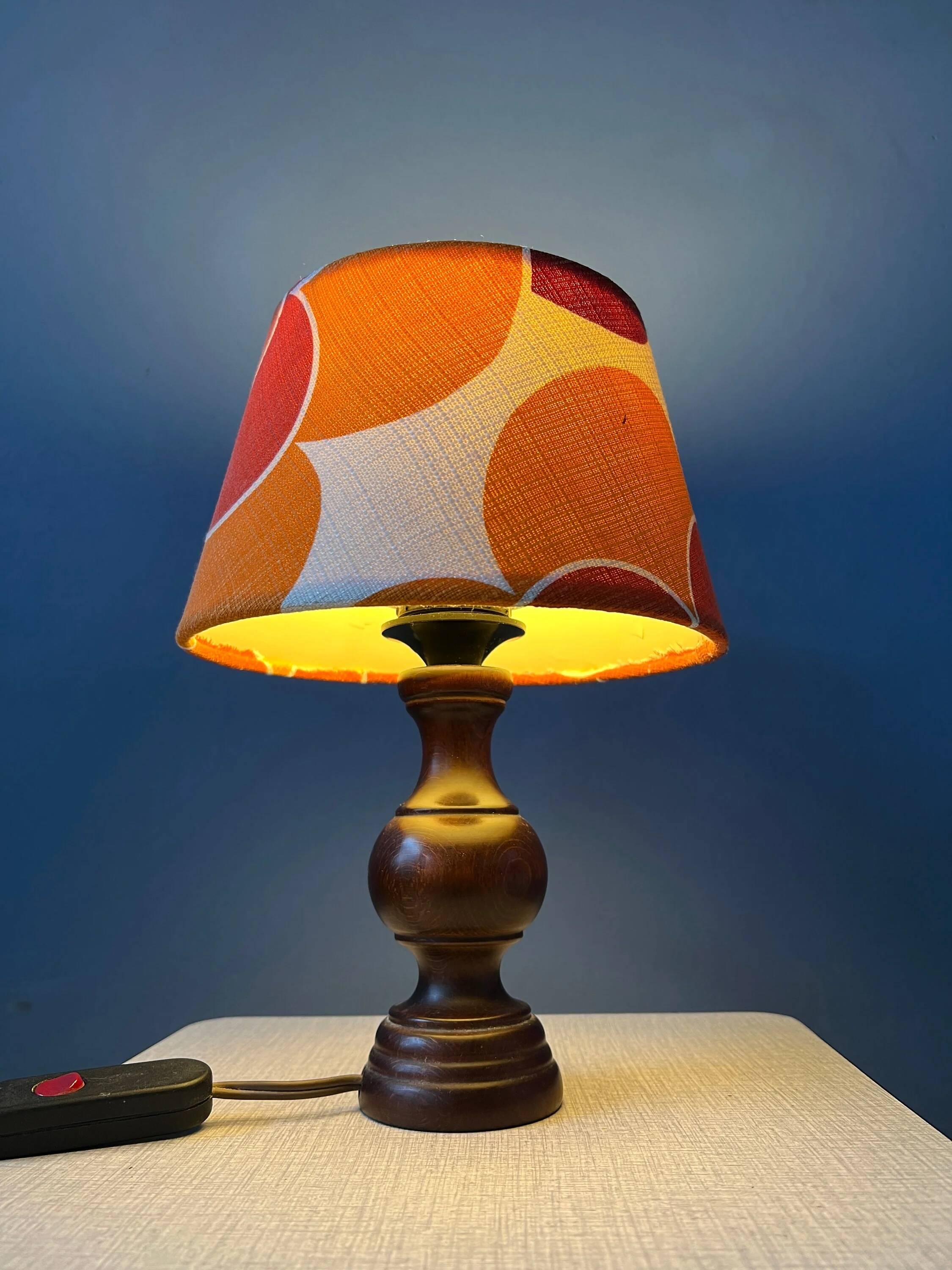 Vintage Space Age table lamp with orange fabric shade.