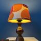 Vintage Space Age table lamp with orange fabric shade.