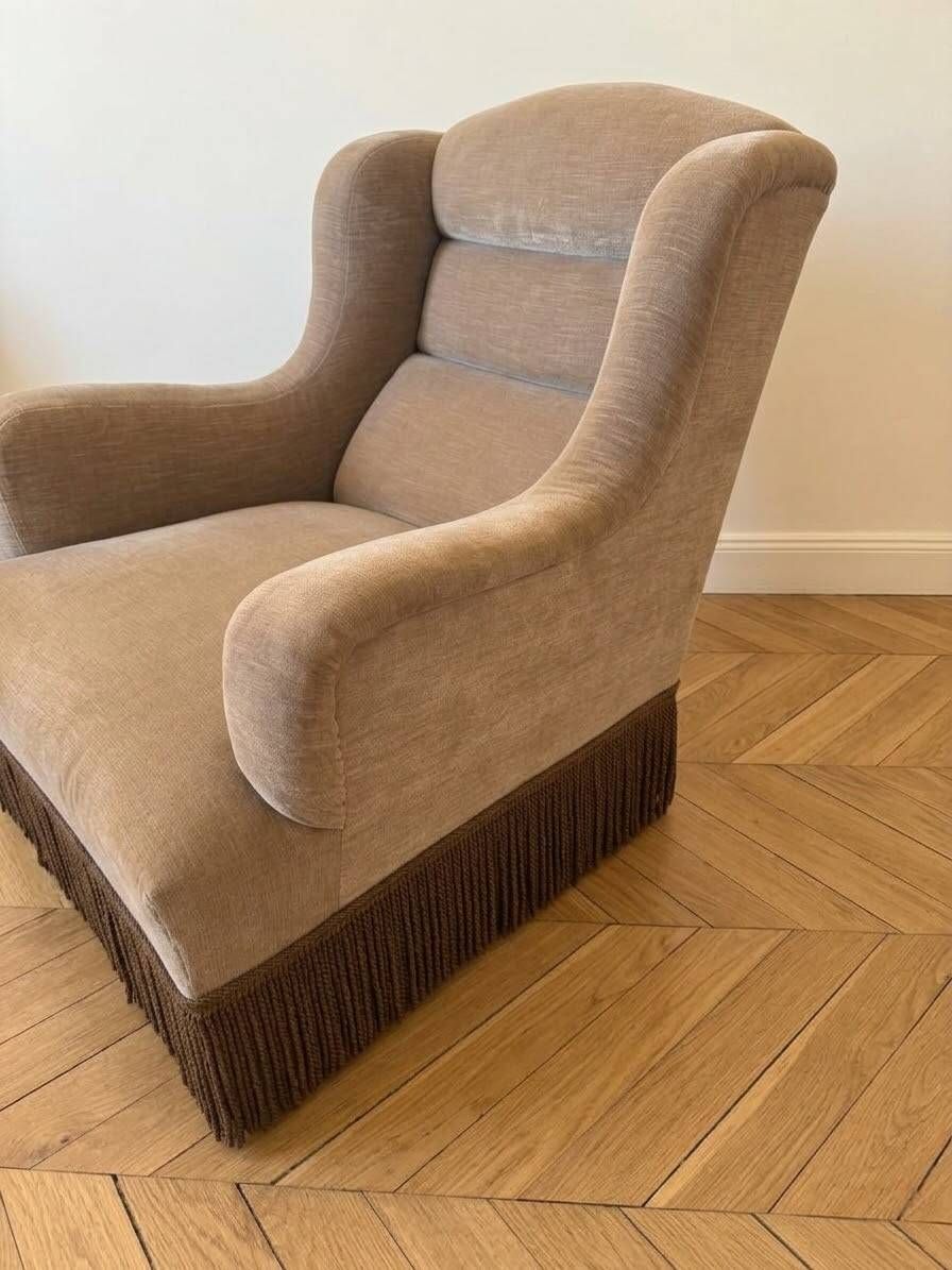 Vintage 1970s armchair in beige fabric with fringes.