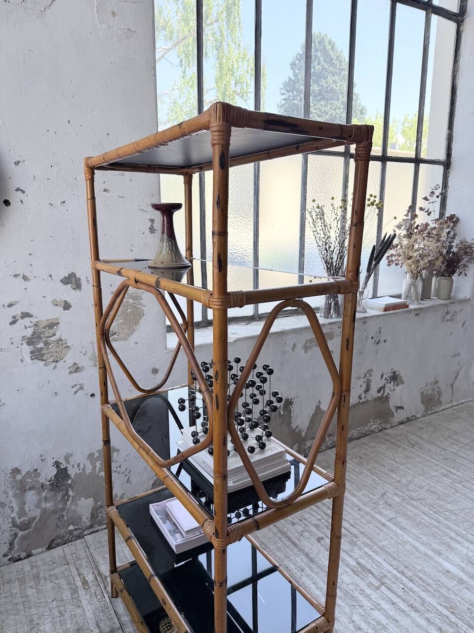 Rattan bookshelf and black glasses