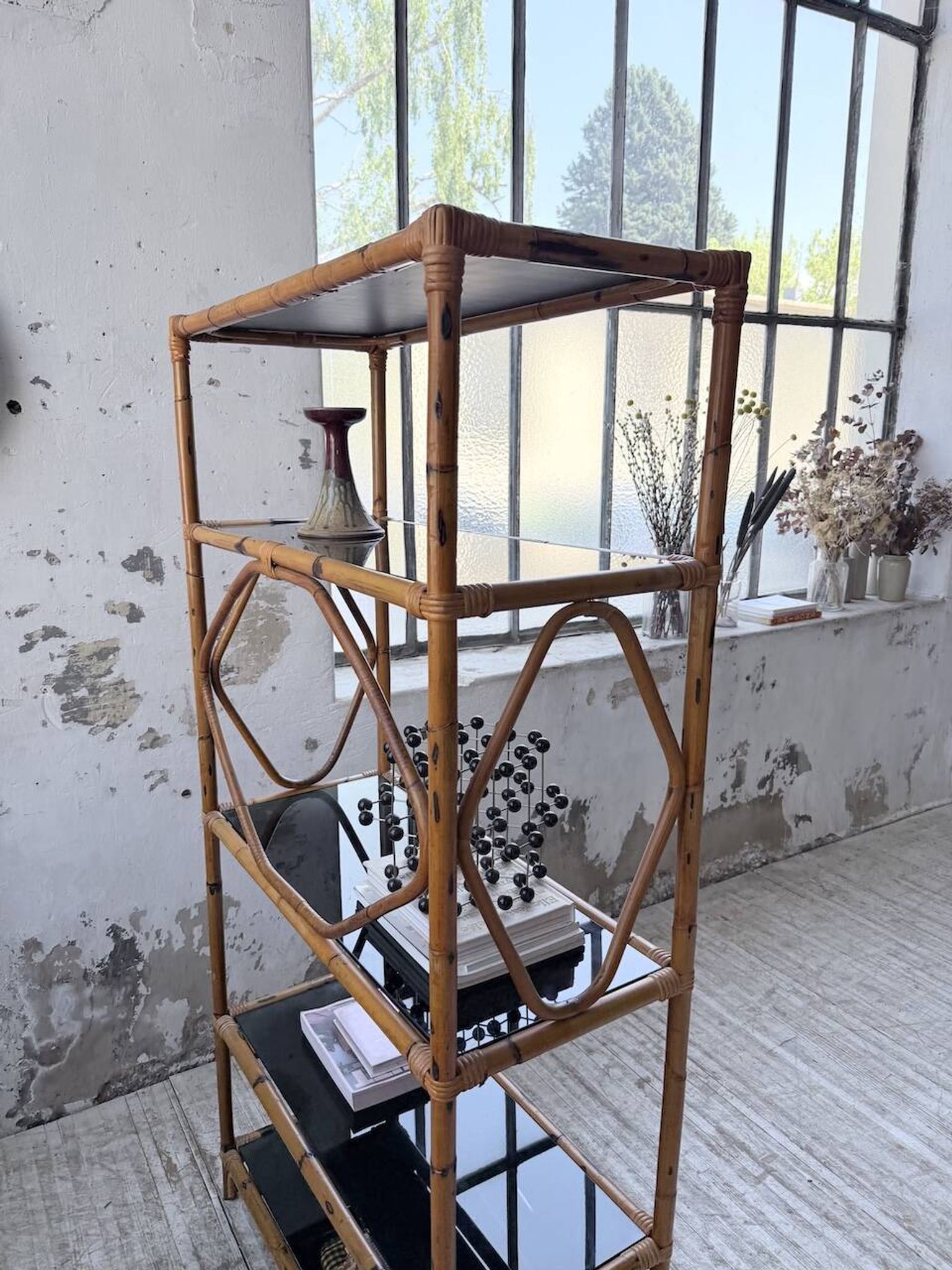 Rattan bookshelf and black glasses