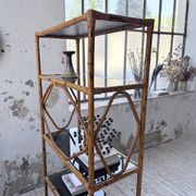 Rattan bookshelf and black glasses
