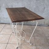 Wrought iron table with a walnut top.