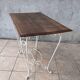 Wrought iron table with a walnut top.