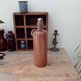 Old bottle in glazed sandstone