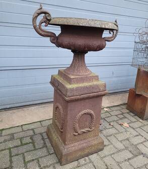 Cast iron garden urn on pedestal with handles