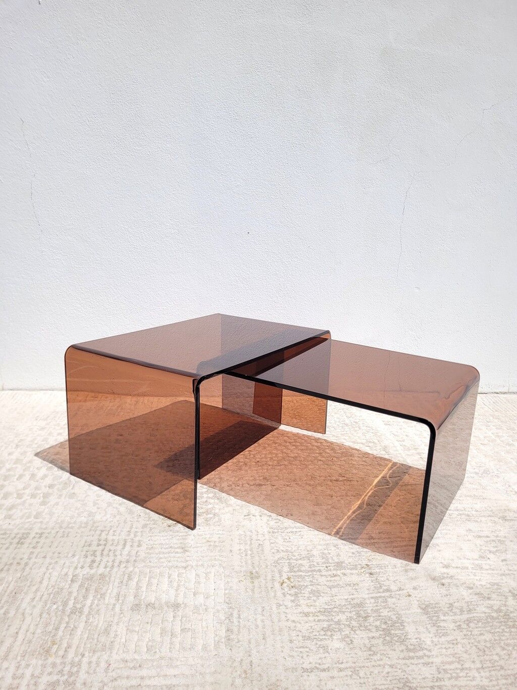 Pair of vintage smoked plexiglass nesting tables.