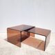 Pair of vintage smoked plexiglass nesting tables.