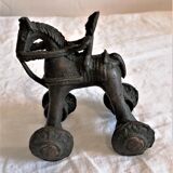 Old child's toy. Horse with bronze wheels. Ethnic object.