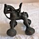 Old child's toy. Horse with bronze wheels. Ethnic object.