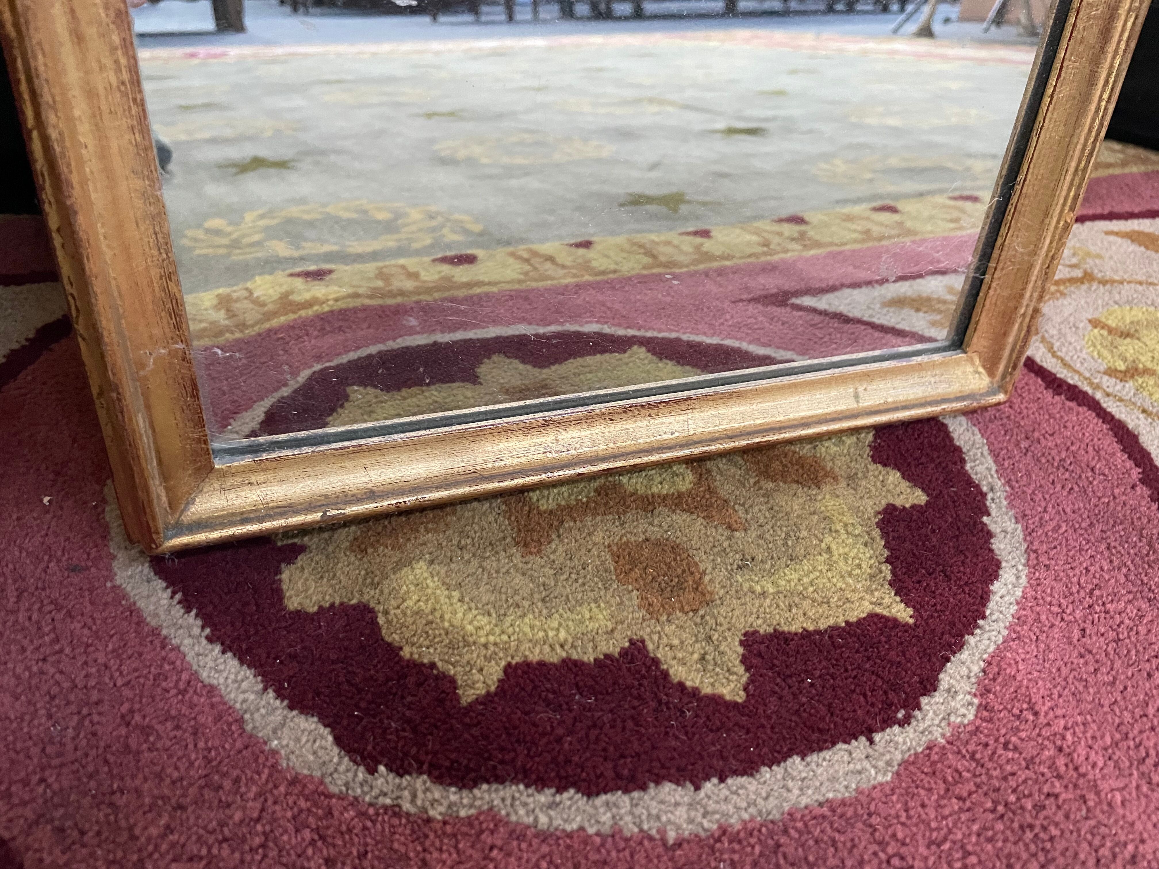 In-between mirror in gilded wood